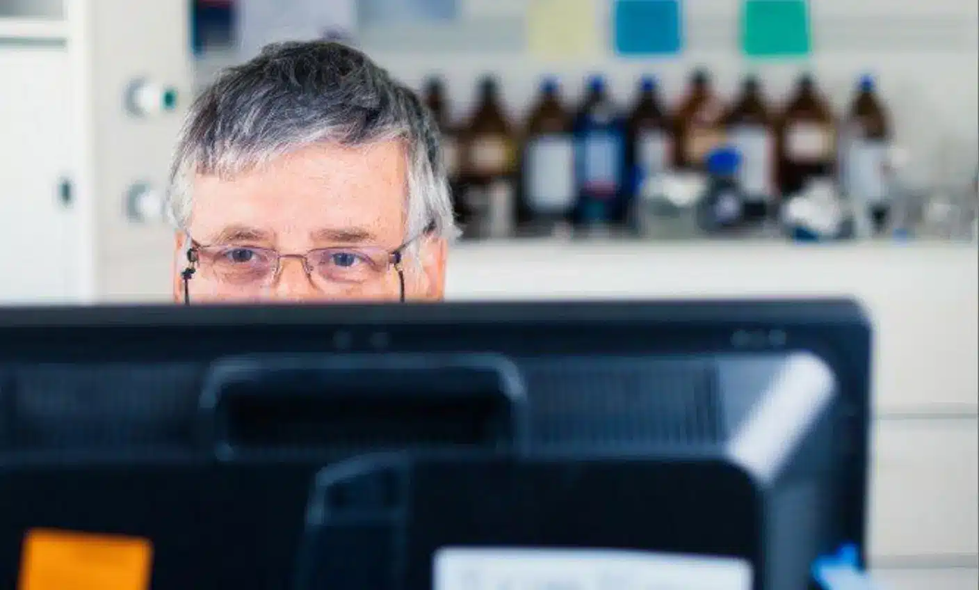 Close up of man working in a computer scren