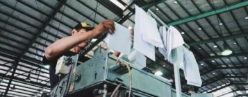 Factory worker following work instructions from a process improvement plan