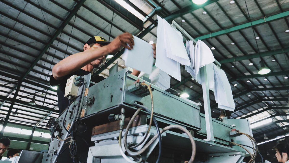 Factory worker following work instructions from a process improvement plan