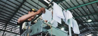 Factory worker following work instructions from a process improvement plan